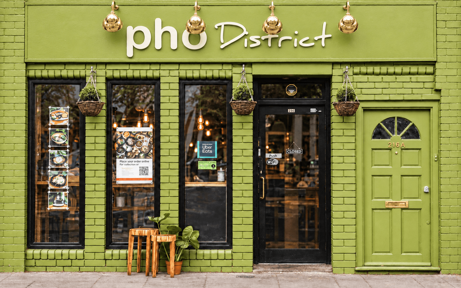 The olive-green Pho District restaurant frontage on King Street in West London